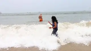 Indian woman enjoying sea bathing at Goa Beach