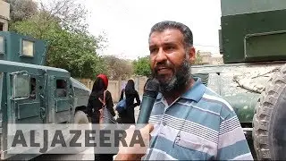 Mosul: thousands flee the city as Iraqi forces try to secure west