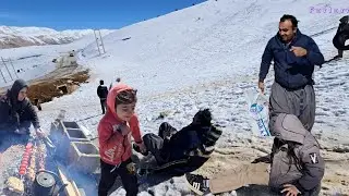 The joy of Khosrow, Sakineh, and the children in the snow: sledding and joy
