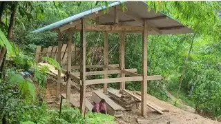 The pregnant woman is planing wood by hand to make flooring and assemble stairs.