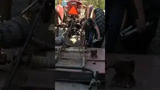 Greasing the Bush Hog Before Mowing the Fields
