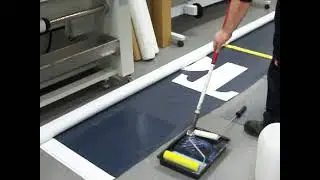Coating large banner with rollers by Hand on floor