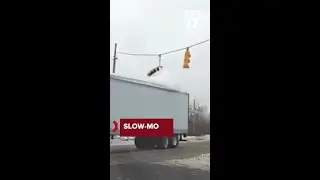 Mound of snow on semi trailer takes out traffic signal