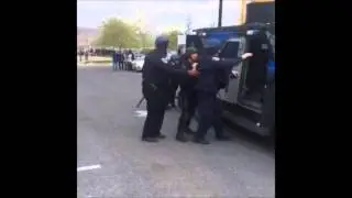 BALTIMORE RIOT: Injured SWAT Officer Loaded In Truck