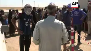 A family from Mosul treks to a neighboring refugee camp in fear of the ongoing counter assaults betw