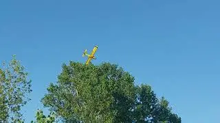 Crop Duster Flying Over the Field Behind Us