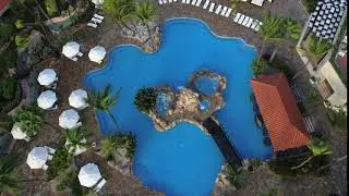 aerial drone shot over tropical resort pool hotel swimming