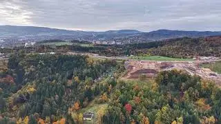 autumn site overview, aerial imagery showcasing construction footprint amid vibrant autumn foliage