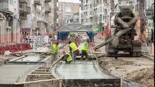 Concrete works for road maintenance construction with many workers and mixer timelapse