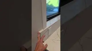 Seamless mitered quartz backsplash to window sill detail