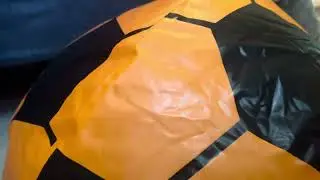 Inflating giant orange soccer ball with a super wubble bubble ball air pump