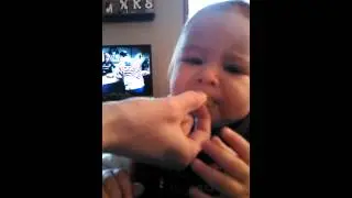 Baby tries pickle for the first time.