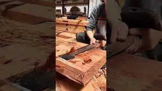 Giant flat chisel chiseling wooden board