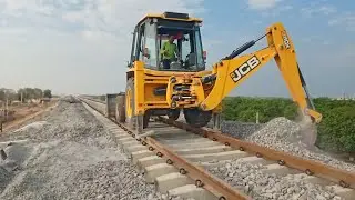 Railway track installation after ballast filling with jcb 3dx