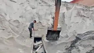 Barge unloading 3600 tons of phosphate powder - Excavator unloads cargo from the barge