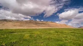 Motion Time Lapse of Clouds over Himalaya Mountains and Green lush Landscape in Ladakh