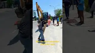 Amateur excavator driver unloading from trailer ramp