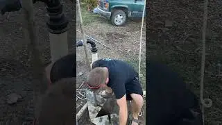Drilling a shallow well with an earth auger.