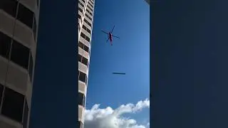 Helicopter lifting a big steel beam November 12, 2022.