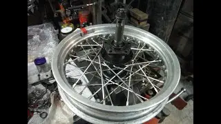 Harley Davidson rear wheel checked after partial rebuild to replace broken spokes.