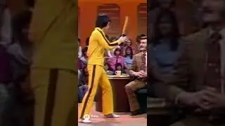 A Bruce Lee&ndash;like master demonstrates a lightning-fast nunchaku micro-stop in a classic TV studio