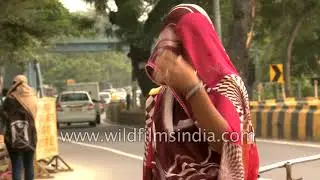 Veiled woman engaged in construction work near Safdarjung Hospital, New Delhi
