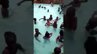 Learning to swim in Uganda. Cyrus swimming with Ugandan kids