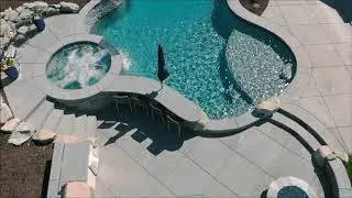 Dream backyard resort swimming pool complete with spa, grotto, waterfall, bar, and firepit!