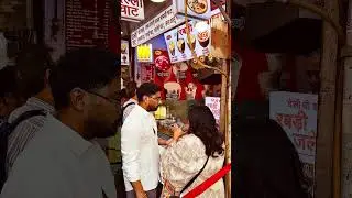 Street stall selling traditional sweet dairy products in Delhi, India.