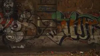 Slow motion dolly shot of graffiti on a wall along a street in Rio de Janeiro, Brazil