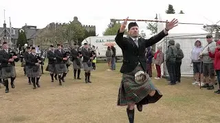 Ellon & District and Newtonhill Pipe Bands march into the 2022 Aboyne Highland Games in Scotland