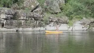Person Wearing T-rex Costume Rides Canoe - 1447935-5