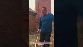 The man is using his natural skills to dismantle a large chimney