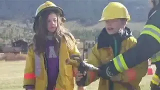 Little kids in big fire boots for firefighter's relay at Summit Cove Elementary