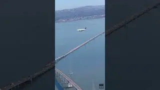 Watch: Illusion of plane makes it look like it's hovering above bridge #Shorts