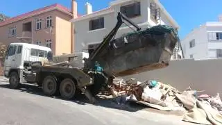 Skip truck loading a 12ton rubble skip