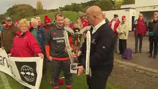 Scott Kennedy, Kinlochshiel receives the Marine Harvest Premiership Trophy from John Angus Gillies,