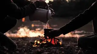 mixkit people pouring a warm drink around a campfire 513 hd ready