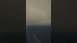 A time-lapse showing clouds rising up a mountain.
