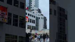 People Walking by Hotel next to Water Canada place in Vancouver