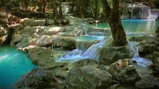 Calming turquoise waterfall cascade. Gentle nature sounds in thai jungle.