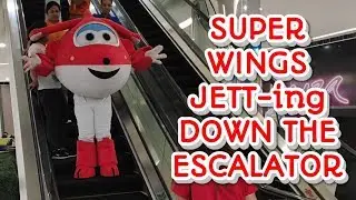 Jett takes the escalator.  Super Wings mascot
