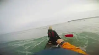 Surfing sea waves in a canoe