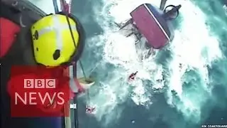 Helicopter rescue of fishermen from a sinking boat