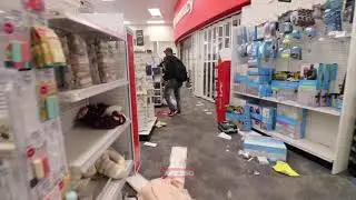 Guy inside pharmacy being looted