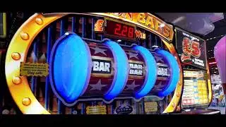 In an unknown arcade with a Bullion Bars slot machine