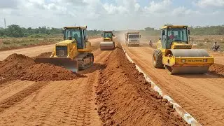 Urban Road Construction with Caterpillar Bulldozer! Pushing a huge  of red dirt in the middle road