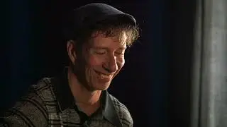 Stuart Matthewman of Sade plays wah wah guitar and takes some pictures.