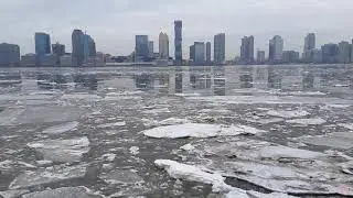 Ice floating down on Hudson river - views from downtown Battery Park and Hoboken NJ