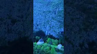 Hidden Waterfall and Enchanting Chapel Nestled in the Mountains